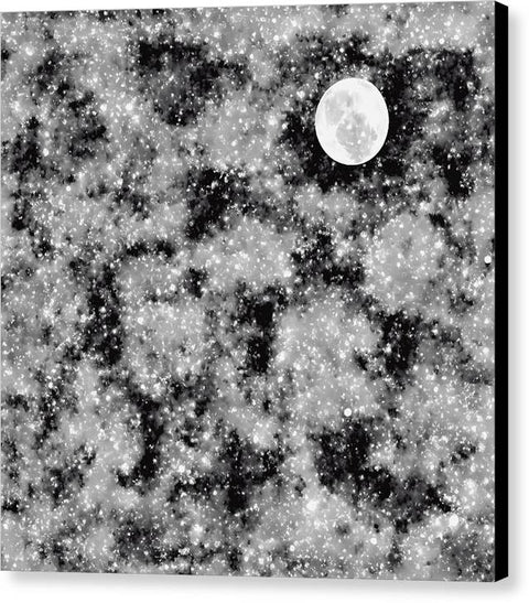 Black and white picture of blanket with blue moon reflecting on metal surfaces