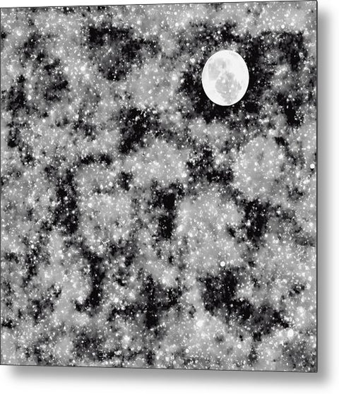 A black and white photo of a moonlit surface with a dark background.