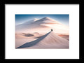 a framed print of two people walking on a sand dune