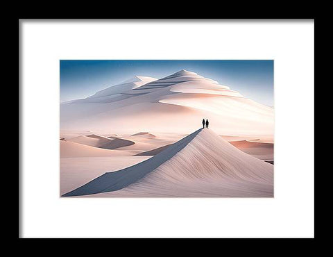 a framed print of two people walking on a sand dune