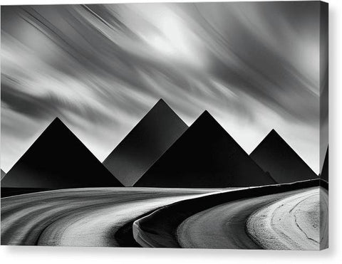 black and white photograph of three pyramids in the desert