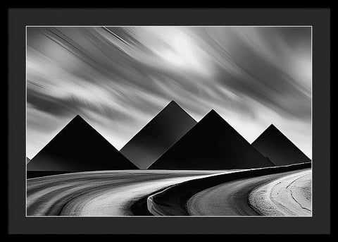 a black and white photo of three pyramids in a desert