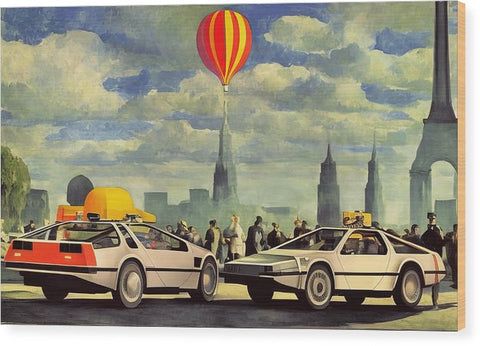 A group of cars are traveling down a road with some air balloons flying in the background