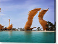 A sculpture of a large metal body of water at the beach in a desert city