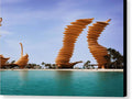 A sculpture of a large metal body of water at the beach in a desert city