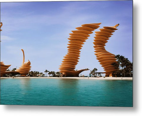 A sculpture of wind turbines on a beach that grows a grassy field