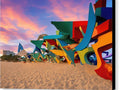 A colorful picture of an interesting wall of art sculptures on a windy beach
