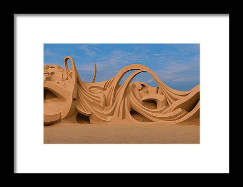 A wooden art print in sand in a beach with beach breakers and waves and some