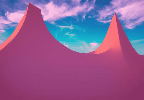 A bunch of pink tents sitting on top of some cliffs in the grass