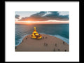 An interesting art print of a lighthouse in a beach with a statue of a man