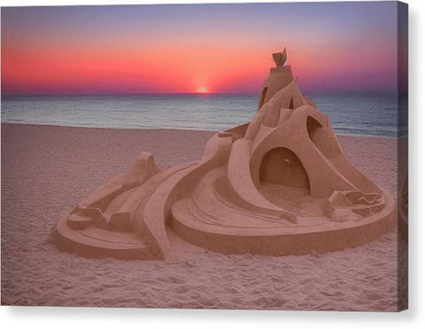 A plastic painted wooden sandcastle in a secluded area with a sun setting beach
