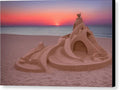 A plastic painted wooden sandcastle in a secluded area with a sun setting beach