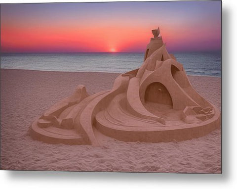 An art sculpture with sun setting in the sand on a beach