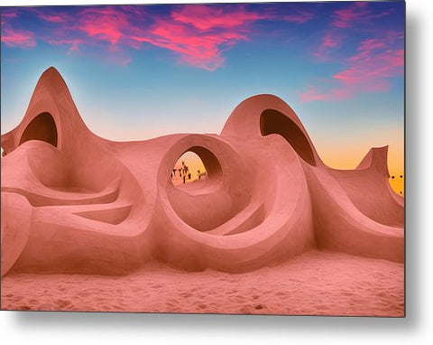 An adobe hut in a desert is in front of the horizon