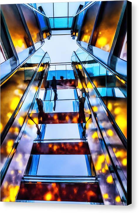 A man on an escalator in a building that has a wall covered in glass