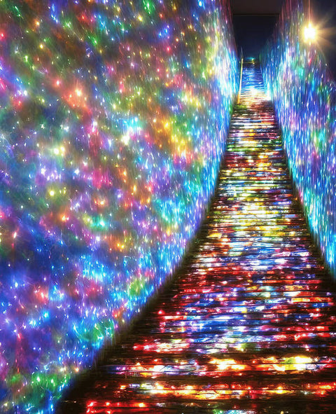 A colorful carpet surrounded by lights in a hallway