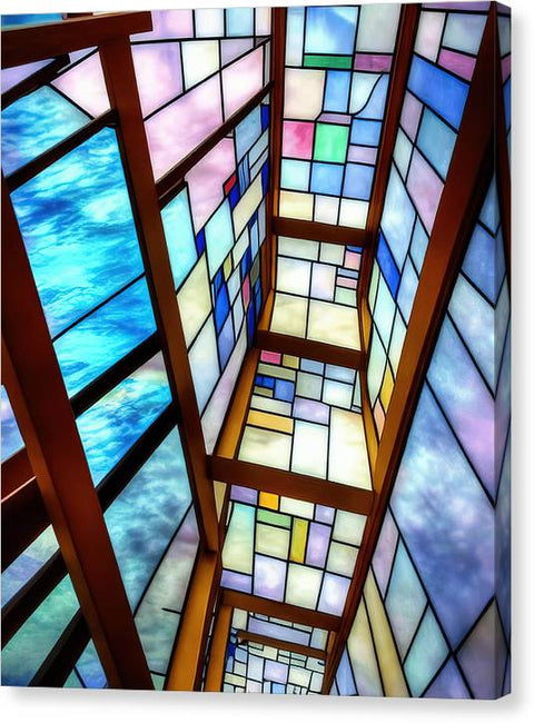 A glass door with stained glass on the ceiling of a church
