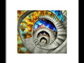 there is a large spiral staircase and there are many art prints surrounding it